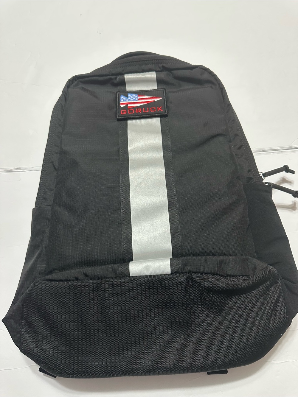 Black Sling Backpack with Reflective Center Stripe